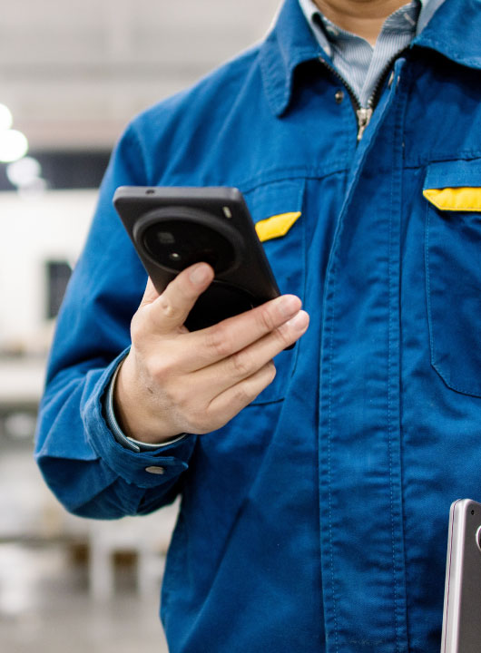 person in blue jacket looking at phone